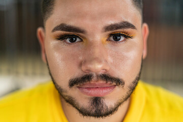 Obraz premium Young LGBT male with beard staring at camera