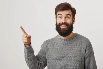 Fototapeta premium Person Pointing Left. Handsome Bearded Man in Grey Sweater Gesturing with Friendly Expression