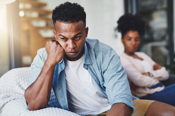 Angry, man and couple with conflict on sofa for cheating, betrayal and affair with ignore or breakup in home. Black people, frustrated and toxic marriage in living room with disagreement and argument