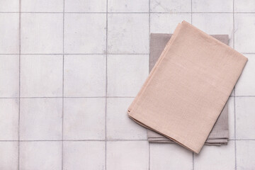Beige napkins on white tile background