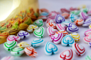 Group of colorful hearts reflected on a golden surface