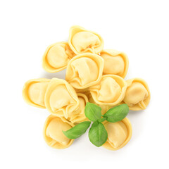 Raw dumplings and basil on white background