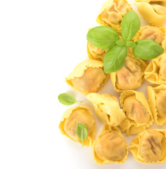 Many raw dumplings and basil on white background
