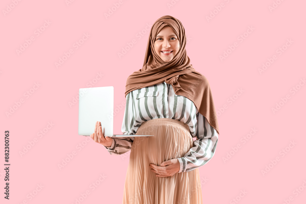 Sticker pregnant muslim businesswoman with laptop on pink background