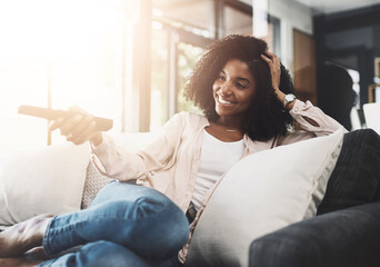Remote, smile and streaming with woman watching tv on sofa in living room of home for break or time off. Comfort, program or video and happy person in apartment with subscription service television
