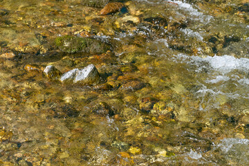 Water flow in a mountain river, close-up. Natural background.