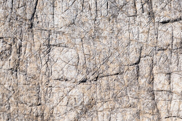 Stone cliff in the mountains, close-up. Natural stone background. Texture of cracks in stone.