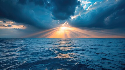 Sunlight breaking through storm clouds at sea