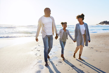 Black family, holding hands and walking with child on beach for bonding, holiday or outdoor...