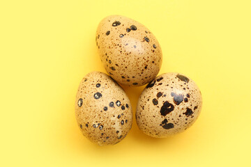Fototapeta premium Fresh quail eggs on yellow background