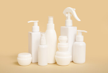 Composition with jars and bottles of cosmetic products on beige background