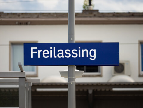 Freilassing train station sign in Bavaria. Location signage of the travel destination near the border to Austria. Public transportation in the region Berchtesgadener Land.