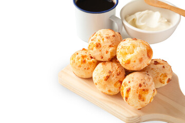 Brazilian pao de queijo mineiro cheese bread isolated png above a wooden plate in clean white soft background in front view