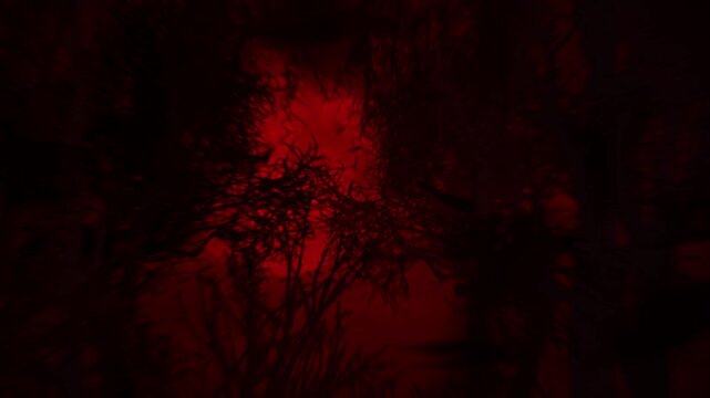 Haunted Forest Silhouette with Bats 4K Loop features a view panning across a forest silhouette with a red glow and full moon in the sky and bats flying across the screen in a loop.
