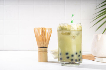 Green matcha boba bubble tea with tapioca pearl. Trendy asian cold iced drink with dark tapioca balls and non-dairy whipped creamed, copy space