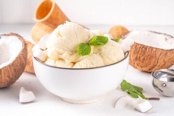 Vegan creamy coconut sorbet ice cream. Bowl with classic white coconut flavor non-dairy vegetarian gelato made with coconut milk, creamy frozen summer dessert