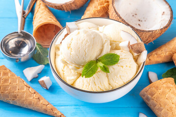 Vegan creamy coconut sorbet ice cream. Bowl with classic white coconut flavor non-dairy vegetarian gelato made with coconut milk, creamy frozen summer dessert