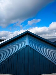 Fototapeta premium A blue roof with a cloudy sky.