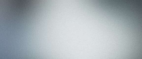Obraz premium Subtle gradient created by abstract light reflecting on a grainy metallic silver background
