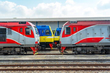 Head locomotive side view of the station platform and commuter train in the parking lot