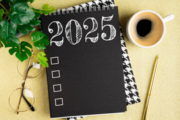 New year resolutions 2025 on desk. 2025 resolutions list with notebook, coffee cup on table. Goals,...