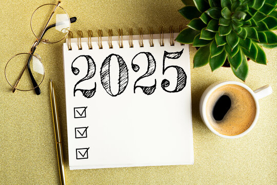 2025 New year resolutions on desk. 2025 goals list with notebook, coffee cup, plant on golden background. Resolutions, plan, goals, action, checklist, idea concept. New Year 2025 resolutions
