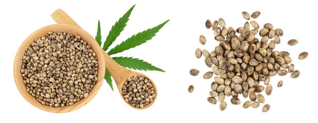 Hemp seeds in wooden bowl isolated on white background with full depth of field. Top view. Flat lay