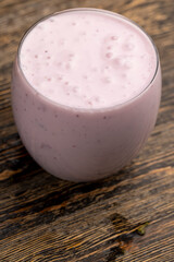 pink yogurt with chunks and taste of red strawberries