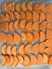 Tray of sweet potato slices ready to bake.
