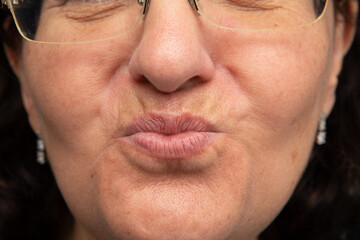 Obraz premium Senior woman wearing glasses is making funny face