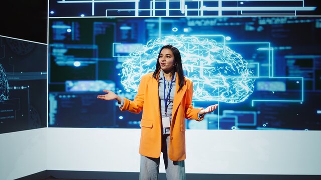 Lively speaker talks at AI event gathering tech startups managers, investors and academics. Expert hosts sessions geared towards helping IT business leaders tap into artificial intelligence, camera B
