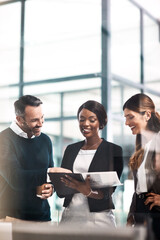 Man, women and documents in team, reading or company proposal in office for advice, check and...