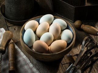 Bowl Full of Colorful Fresh Eggs on Wooden Table