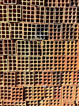 Stack of terracotta hollow bricks in construction site
