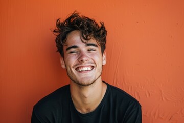 Obraz premium The young man has a bright smile and his image is perfect for expressing confident abstract concepts, making it a best-selling background or wallpaper