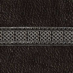 Seamless 4k photo texture photo of black colored leather material with ornate celtic or viking style steel border.
