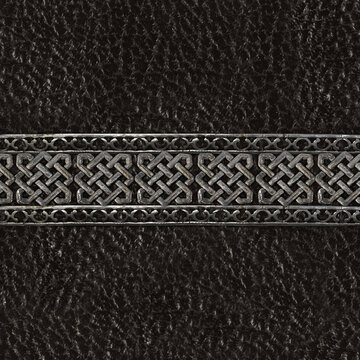 Seamless 4k photo texture photo of black colored leather material with ornate celtic or viking style steel border.