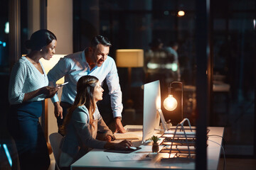 Business people, team and night with computer for deadline, project or brainstorming design at...
