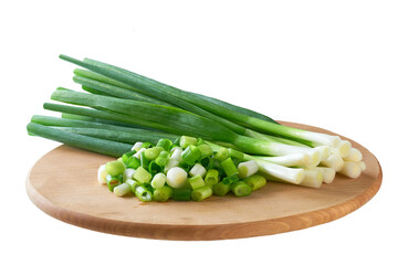 Fresh spring onions or scallions on a cutting board isolated on a white background.