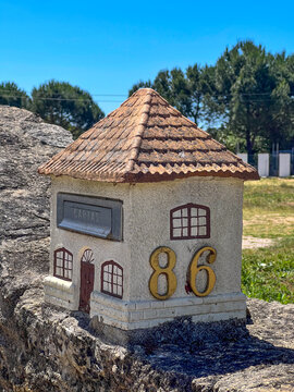 Miniature house shaped mailbox with number 86 in Portugal