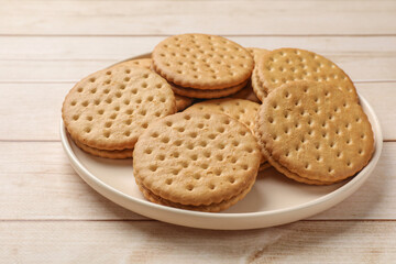 Fresh tasty sandwich cookies on wooden table