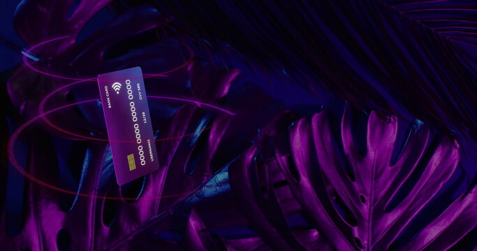 Credit card floating among vibrant tropical leaves, showcasing modern finance - Powered by Adobe