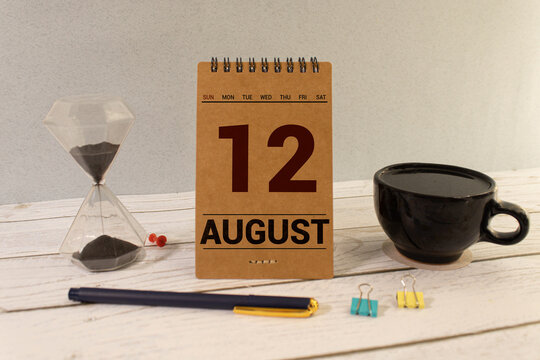 August 12 calendar date text on wooden blocks with blurred background park.