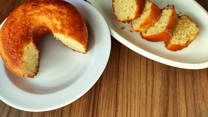 Traditional cornmeal brazilian cake and slices on the wooden table with copy space. Food from Minas Gerais state and from brazil.
