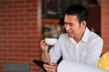 Portrait of a handsome young manworking with laptop in coffee shop cafe smile and happy face.