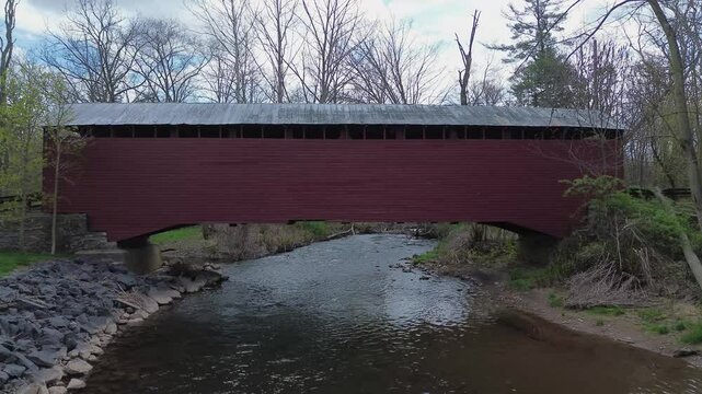 Parr's Mill covered bridge near Catawissa, PA. Flying shot at stream level towards the side of the bridge that rises to the roof line. Shot in early Spring.