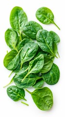 Fototapeta premium Pile of fresh green baby spinach leaves isolated on white background. Close up. Flat lay. Food concept. Macro concept