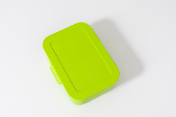 green closed lunch box or container on white background with space for text