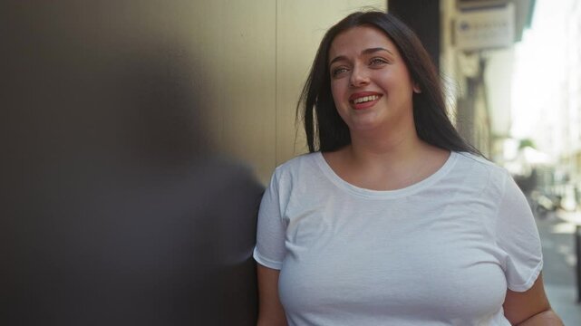 Woman in white shirt smiling outdoors in urban street setting