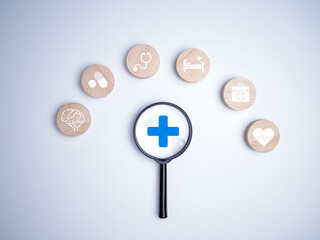 A magnifying glass focus on the plus sign and healthcare medical icon on white background, Health insurance concept, Health and access to welfare health concept, Healthy and lifestyle.